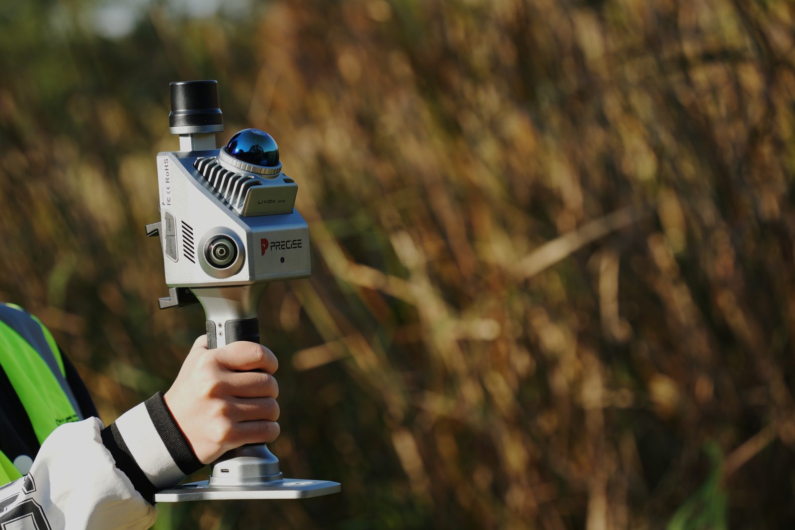 Surveyor holding PRECISE S2 in the field